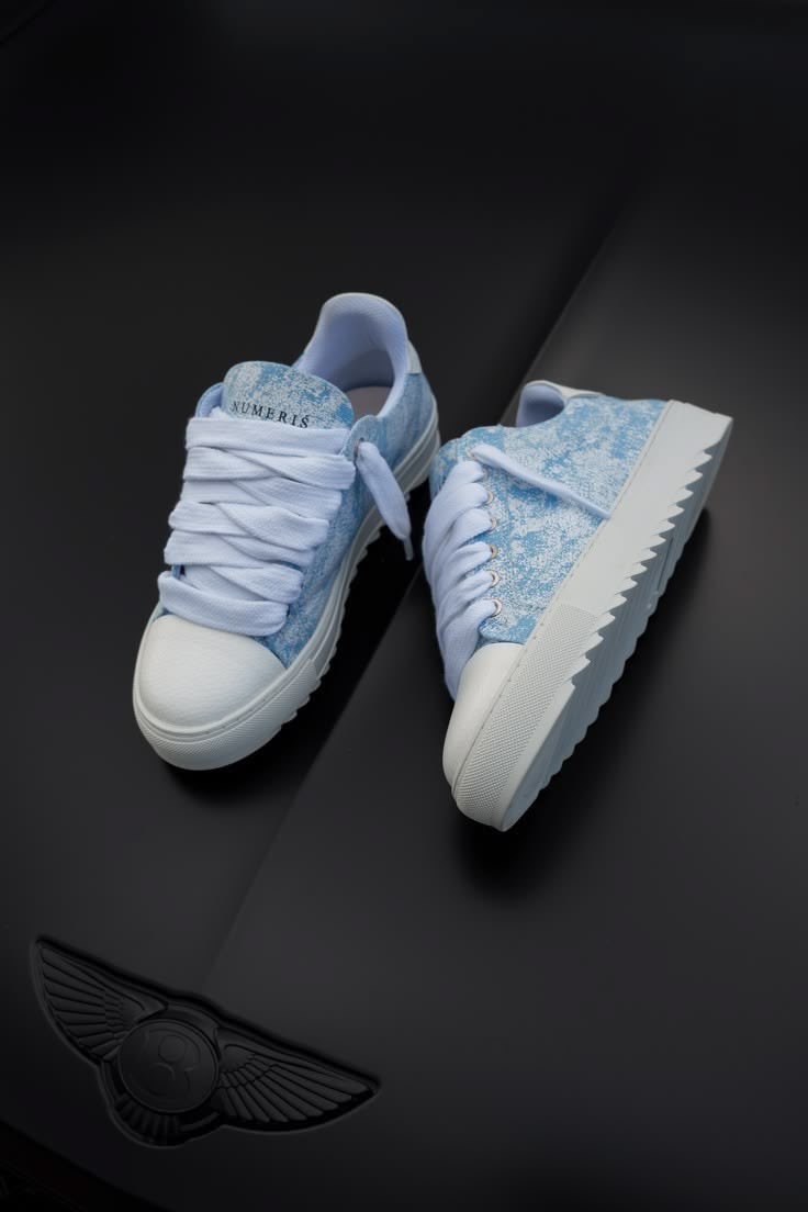 Sky blue and white low-top sneakers in the Style Sports Global collection